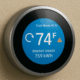 A modern smart thermostat is shown, prominently displaying real-time energy usage data and maintenance alerts for the HVAC system