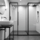 In this modern bathroom design, white walls and bright green accents create a serene space