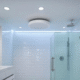 A modern bathroom featuring a ceiling-mounted exhaust fan located directly above the shower area, designed to improve air quality by reducing moisture and humidity.