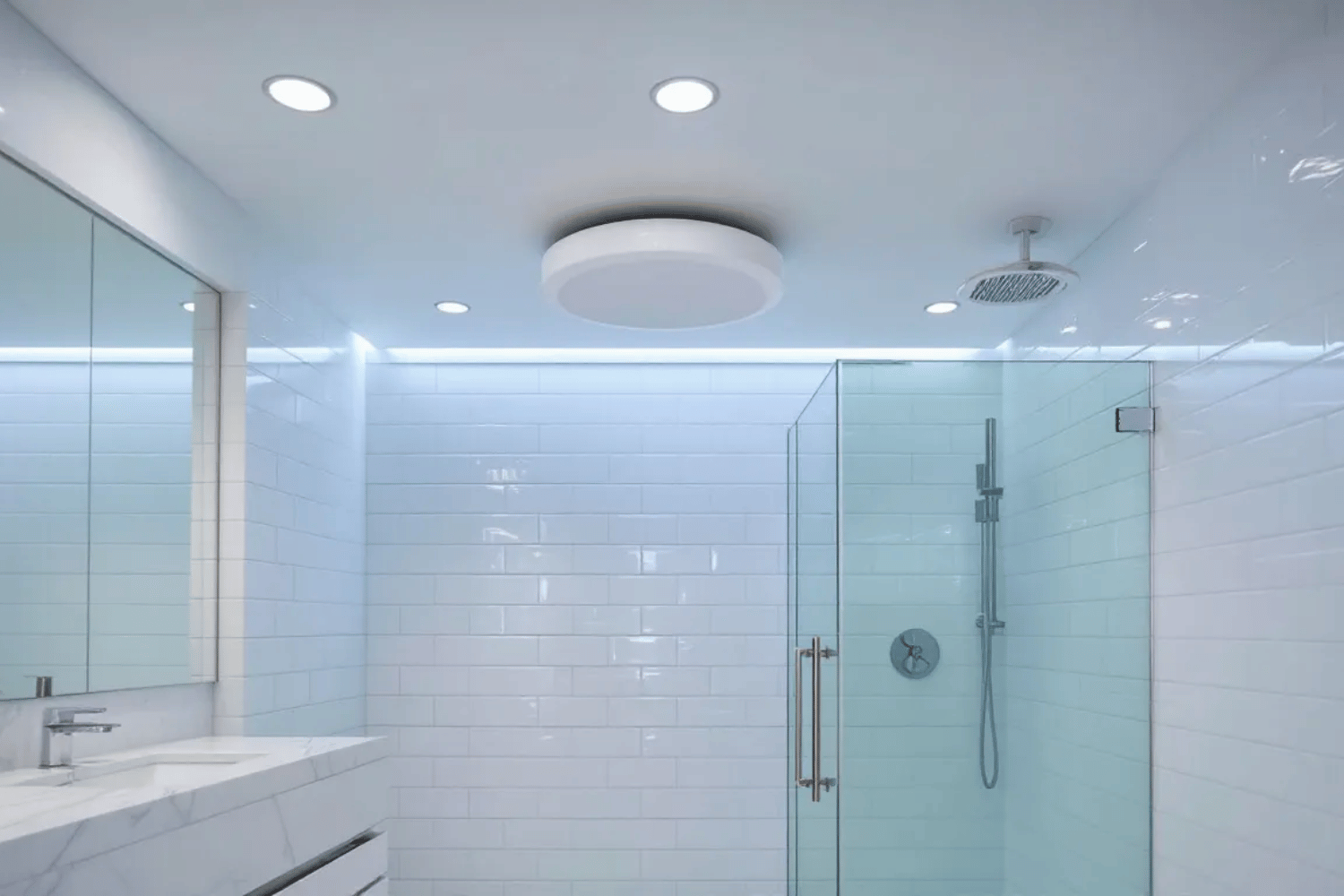 A modern bathroom featuring a ceiling-mounted exhaust fan located directly above the shower area, designed to improve air quality by reducing moisture and humidity.